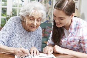 46634496 - teenage granddaughter helping grandmother with crossword puzzle